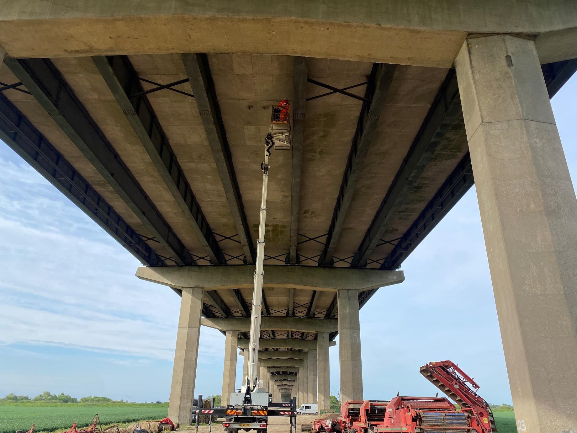Underside of the M62 Ouse Bridge with an underbridge unit and inspector at the girders